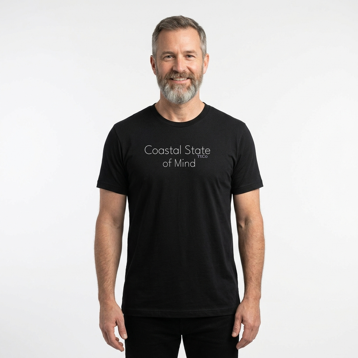 Graham wearing the Coastal State of Mind T-shirt from TtCo with the design centered on the front. White letters on a black tee. TtCo