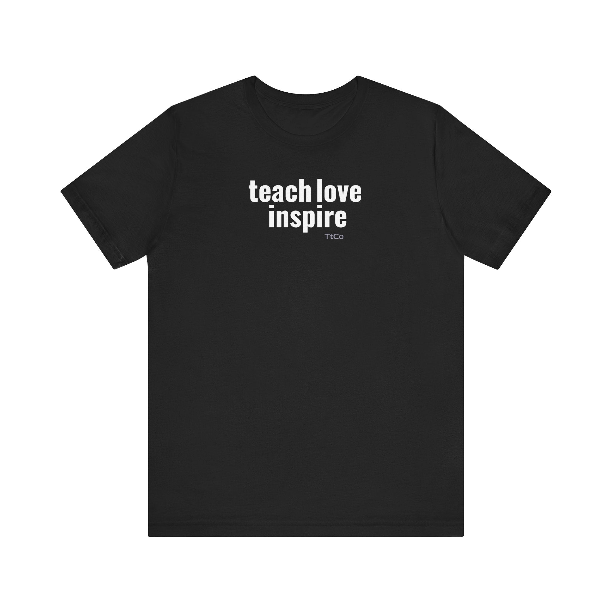 Teach Love Inspire print on the front of a black TtCo T-shirt on a white background.