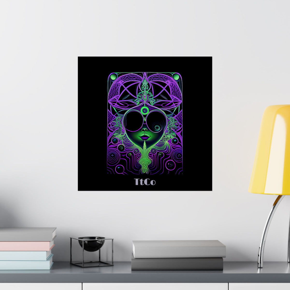 A black poster print hanging on a white wall, featuring a colorful psychedelic face illustration in purple, green, and neon tones, with the text 'TtCo' at the bottom. TtCo | Hello Alice Premium Matte Poster PROOF Ultra Rare
