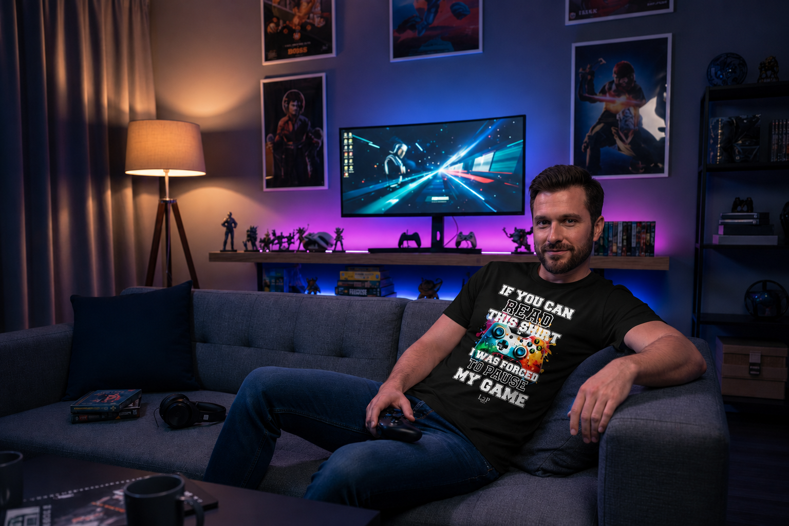 Man sitting on a couch in a gaming room wearing a black TtCo | Gamer T-shirt — If You Can Read This.